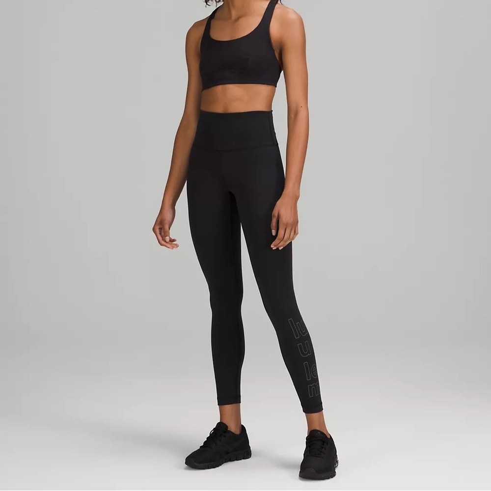 Brand new Lululemon black leggings with the word “Lululemon” on the leg size 4